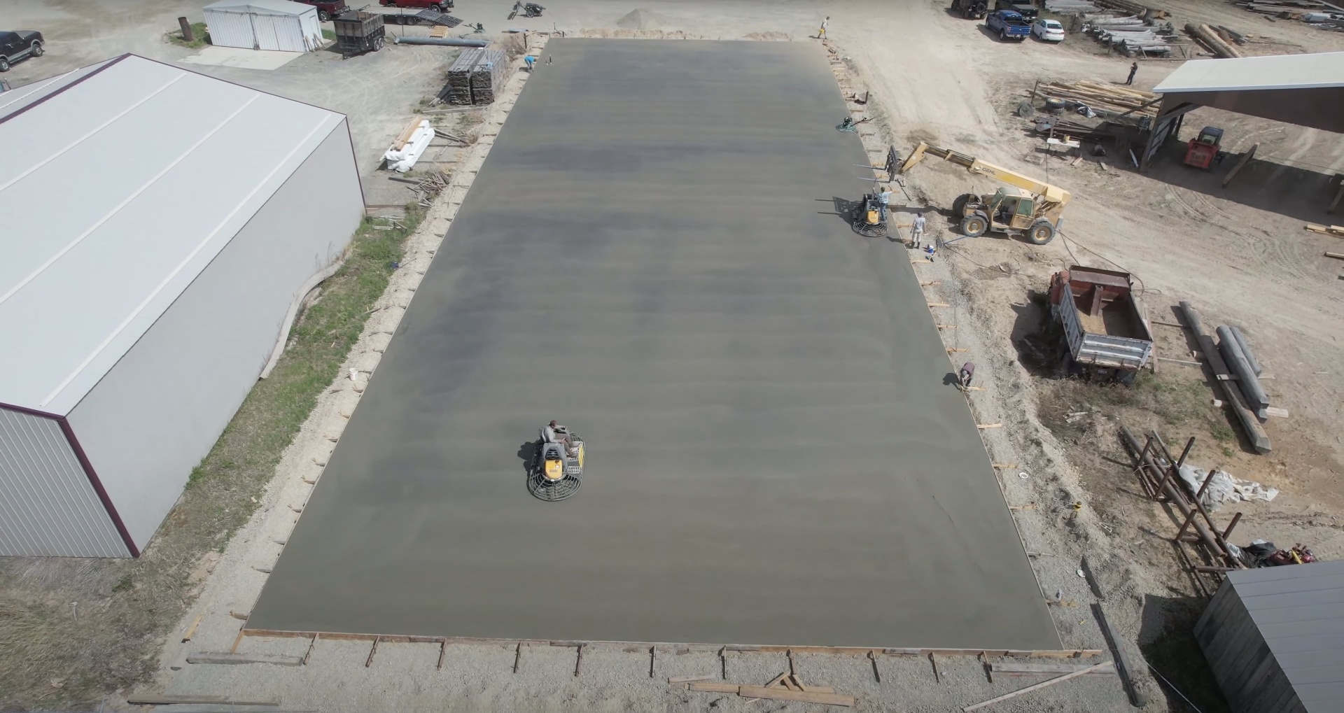 Commercial concrete slab installation using professional-grade equipment Large commercial concrete slab installation with professional equipment