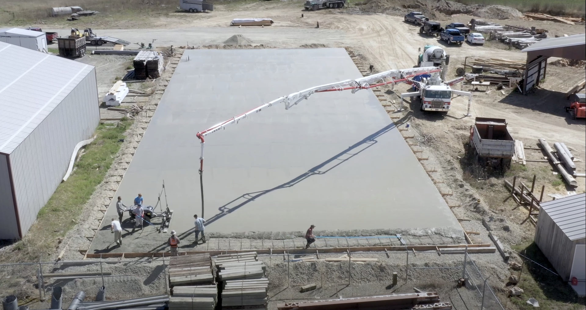 Commercial concrete foundation work and large-scale projects Large commercial concrete pour showing professional equipment and team