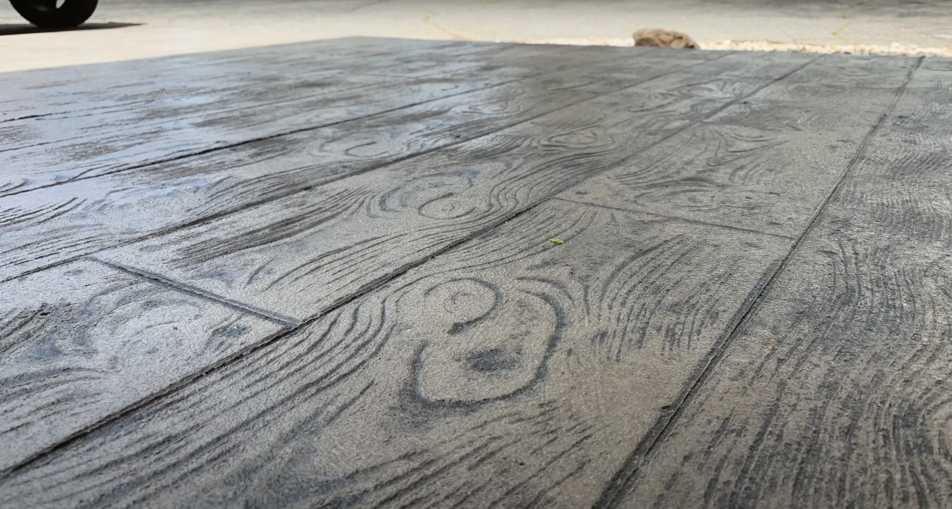 High-quality stamped concrete with realistic wood grain pattern and texture Stamped concrete with detailed wood grain texture and professional craftsmanship