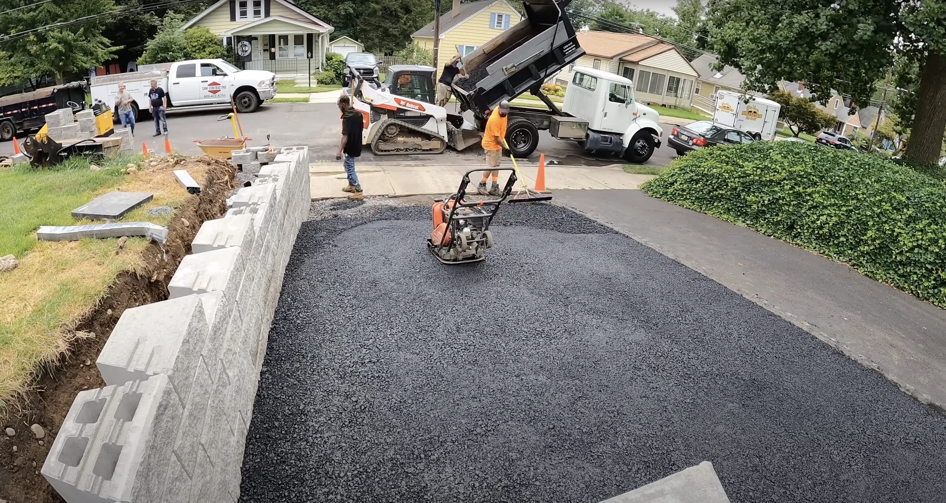 Professional street repair and concrete work with specialized equipment Asphalt and concrete street repair work with professional crew and equipment
